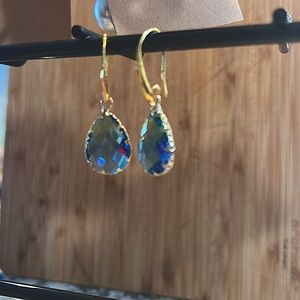Crafted gold tone earrings w/blue crystal tear drop.